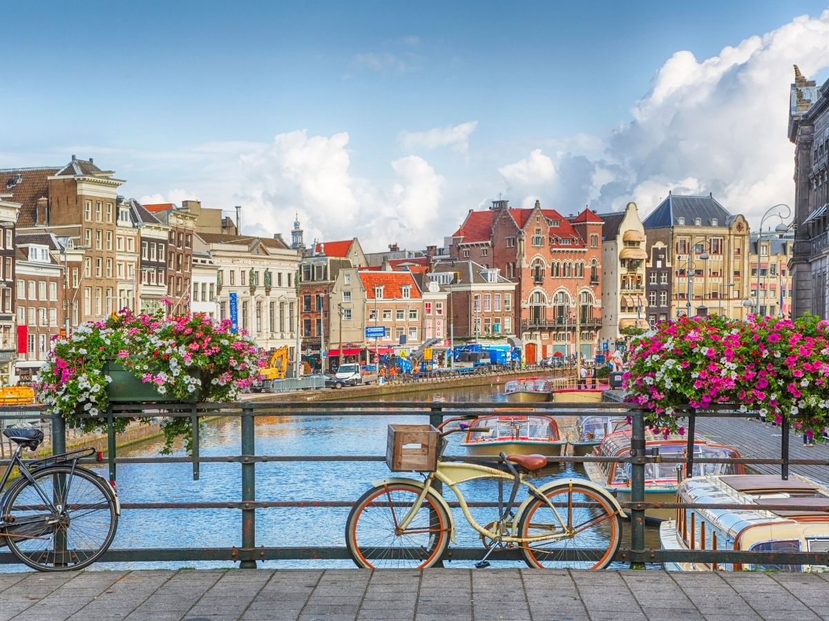Amsterdam canals, traditional houses, and bridges with prepaid travel eSIM providing reliable mobile data connectivity.